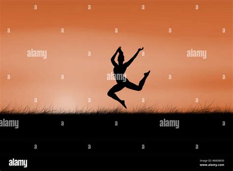 Fit Brunette Jumping And Posing Against Sun Rising Stock Photo Alamy