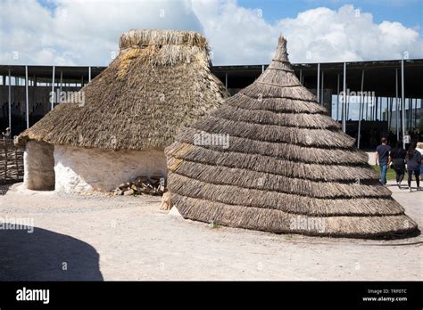 Exterior of recreated Neolithic stone age hut / stoneage huts with ...