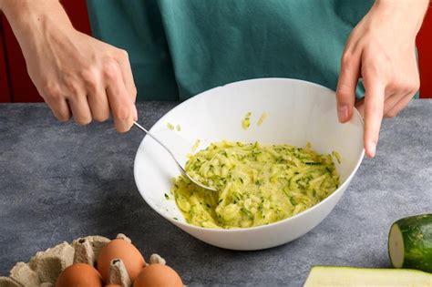 Premium Photo Female Hands Mixing With Fork Beaten Eggs And Grated