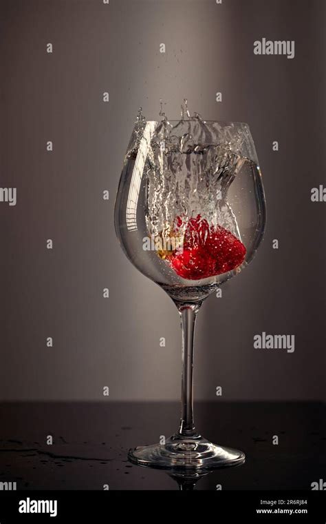 Strawberries Dropped Into A Glass Of Water Stock Photo Alamy