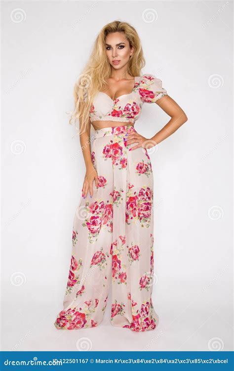 Beautiful Sexy Elegant Woman With Blonde Hair Poses In The Studio In Elegant Clothes With