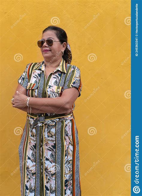 Mature Woman With Her Arms Crossed Looking Away From The Street Stock