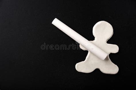 A Small White Plasticine Man Holding A Chalk On A Black Board Copy