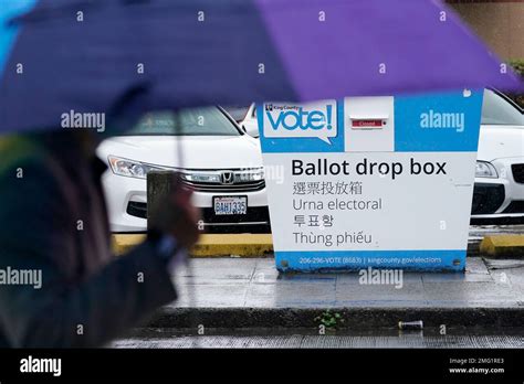 A Pedestrian Walks Past A King County Ballot Drop Box Closed Until