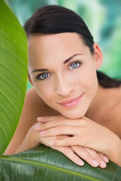 Beautiful Nude Brunette Smiling At Camera With Green Leaf Stock Photo