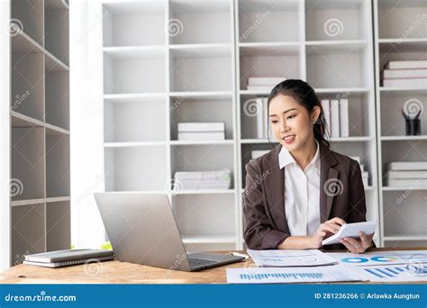 Attractive Asian Female Accountant Wearing Formal Suit Calculating Cash