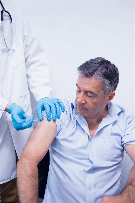 premium photo doctor giving injection   patient