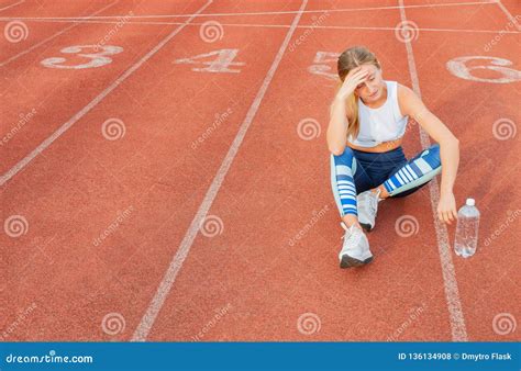 Tired Woman Runner Taking A Rest After Run Sitting On The Running Stock