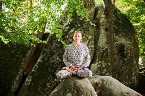 Woman Practicing Yoga Outdoors In Forest Barefoot Female On Yoga Mat