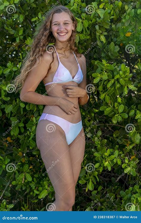 Lovely Blonde Bikini Model Posing Outdoors On A Caribbean Beach Stock