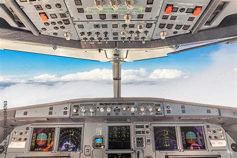 cockpit view of a commercial jet airliner with pilot in cruise phase of ...