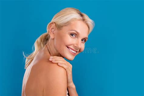 Photo Of Dreamy Shiny Senior Woman Nude Shoulders Applying Body Lotion Empty Space Isolated Blue