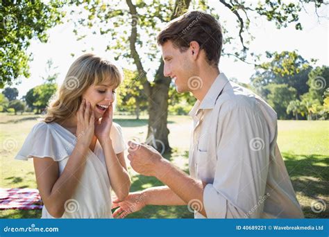 Man Surprising His Girlfriend With A Proposal In The Park Stock Image