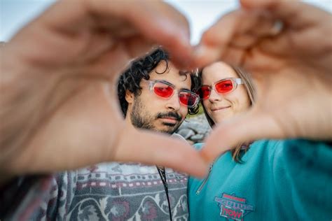 A Couple Forming a Heart Shape with Their Hands · Free Stock Photo