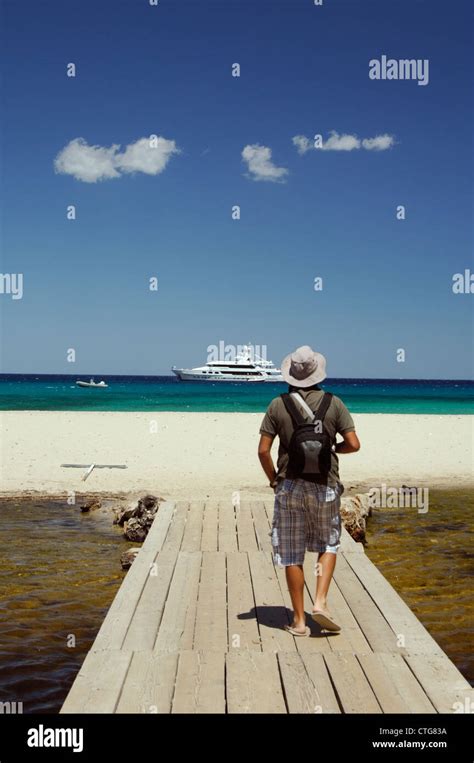 Tourist And Luxury Yacht At Cala Luna Beach Cala Gonone Sardinia