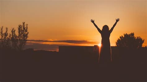 Premium Photo Silhouette Woman Standing With Arms Raised Against Orange Sky