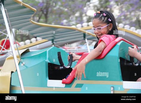 Year Old Latin Brunette Girl With Glasses Has Fun On An Amusement