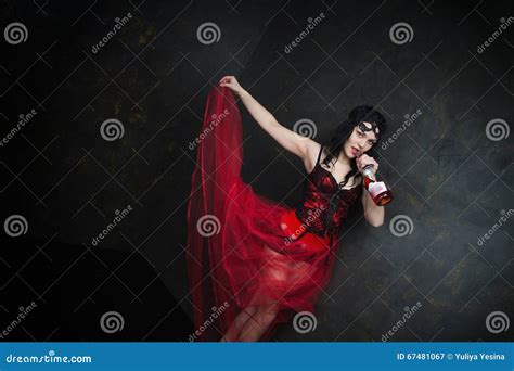 Happy Beautiful Brunette Woman In Corset And Long Hair With Bottle Of Red Wine Stock Image