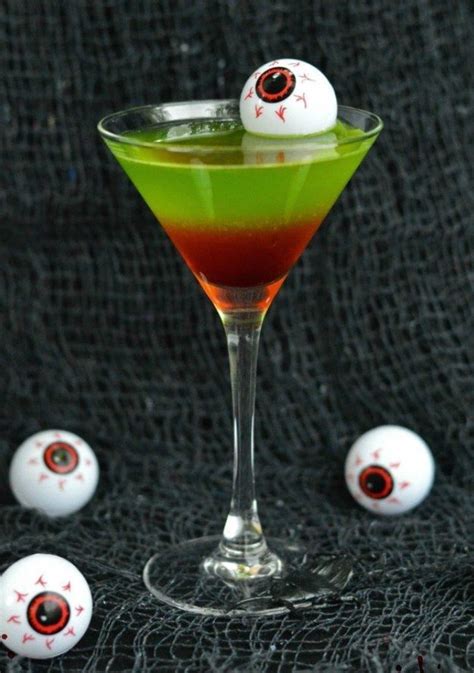 a halloween drink with eyeballs in the glass