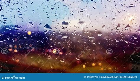 Rain Drops On The Surface Of Clear Glass With Sunset Bokeh Background