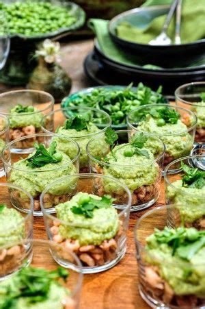 Many Small Cups Filled With Food On Top Of A Wooden Table