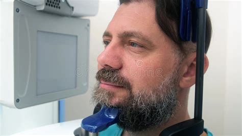 Scanning of the Dental Jaw. Male Patient Undergoing Panoramic X-ray ...