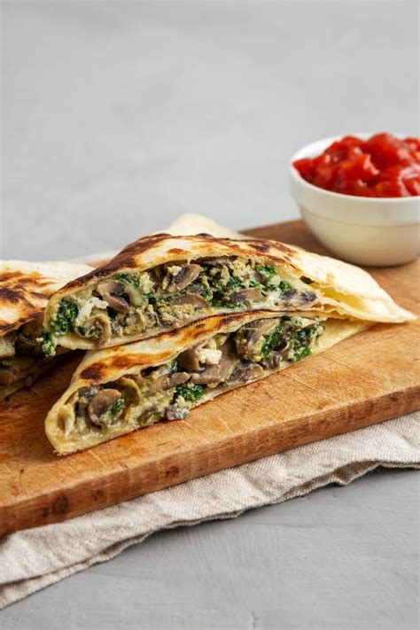 Homemade Spinach And Mushroom Quesadilla With Salsa On A Rustic Wooden Board Side View Stock