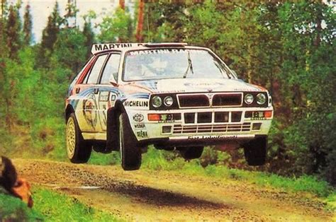 A Rally Car Jumping Over A Dirt Road