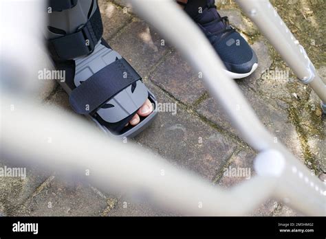 Women Broken Feet With A Grey Plastic Boot Ankle Brace Injury