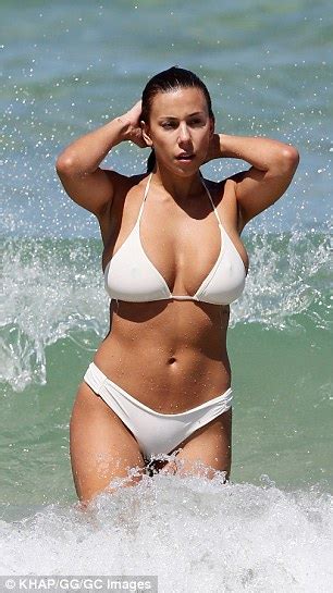 Devin Brugman Pictured As She Emerges From The Water In A White Bikini