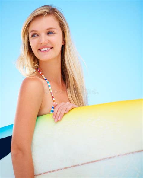 Ready To Catch Some Waves A Pretty Blonde On The Beach Holding Her