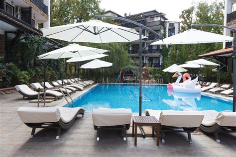 Summer Vacation. Swimming Pool of Luxury Hotel with Umbrella and Chair Around Stock Photo ...