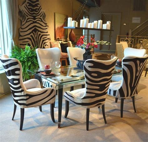 Zebra Print Chairs And A Glass Table In A Room