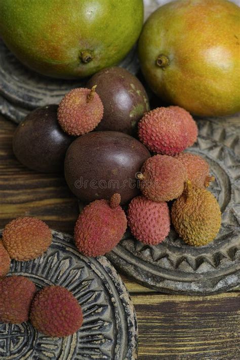 Lychees And Passion Fruit Or Maracuya And Mango On Wooden Background Exotic And Tropical