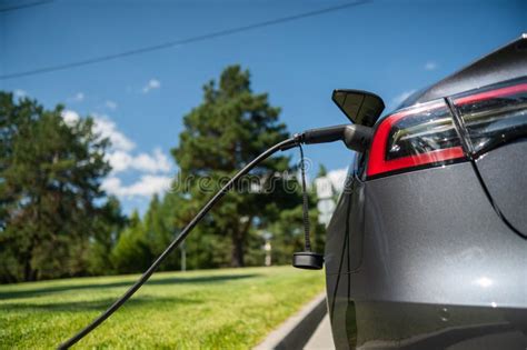 Black Electric Car Charging Outdoors in Summer. Stock Image - Image of ...