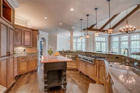 A Large Kitchen With An Island In The Middle Of It And Lots Of Counter