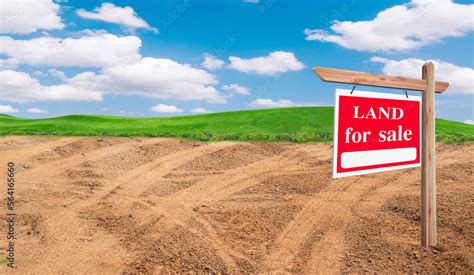 House symbol and land for sale signboard and empty dry cracked swamp ...