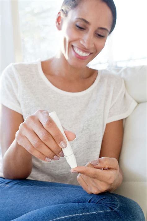 Woman Doing Pin Prick Test On Finger Photograph By Science Photo