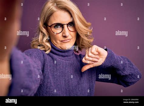 Middle Age Beautiful Blonde Woman Wearing Sweater And Glasses Make Selfie By The Camera With