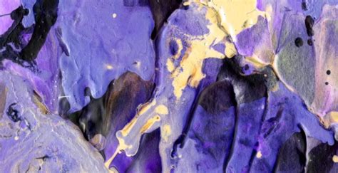 Premium Photo | A close up of a purple paint with yellow and purple paint