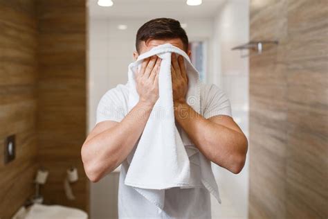 Hombre Se Limpia La Cara Con Una Toalla De Higiene Matutina Imagen De