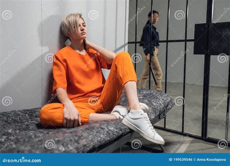 Blonde Inmate In An Asian Women S General Security Prison Is Led Out Of Her Cell By A Uniformed