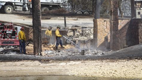 Firefighters Extinguish Smoldering Wreckage After Wildfire On Possum