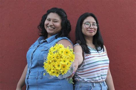 Latina Sisters And Friends Brunettes Give Each Other Yellow Flowers To Show Their Love And The