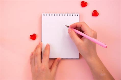 Premium Photo Paper Cut Hearts Notepad On Pastel Pink Background