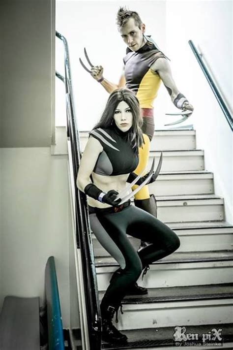 Two People Dressed As Wolverine And Catwoman On The Stairs With Swords