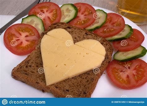 Heart Shaped Cheese Sandwich With Vegetables On White Plate Stock