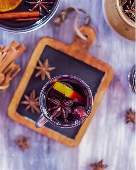 An Overhead View Of A Drink In A Glass On A Tray With Spices And Cinnamons