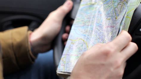 Close Up A Man Holding A Map And Driving A Car Stock Video Footage