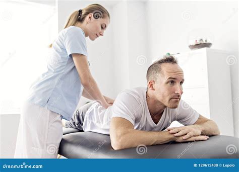 Patient At The Physiotherapy Doing Physical Exercises With His